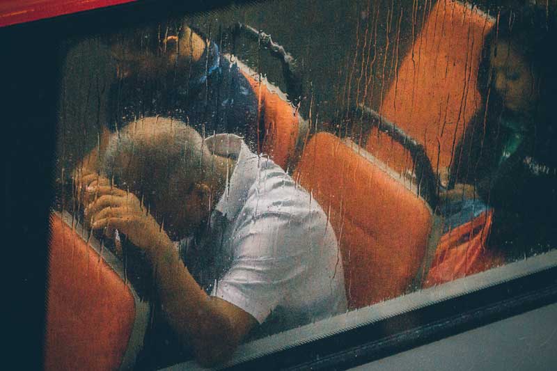 Photo of man on bus in pain.